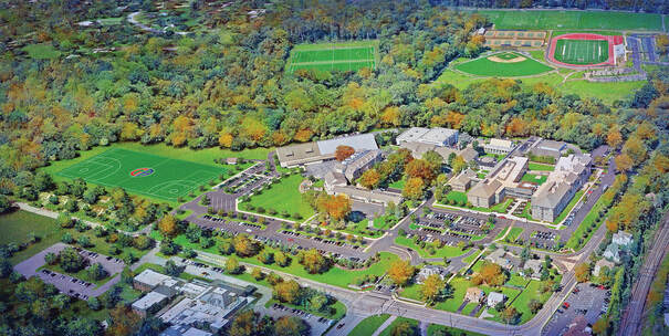 Aerial view of the Atlanta host campus surrounded by athletic fields and autumn trees.