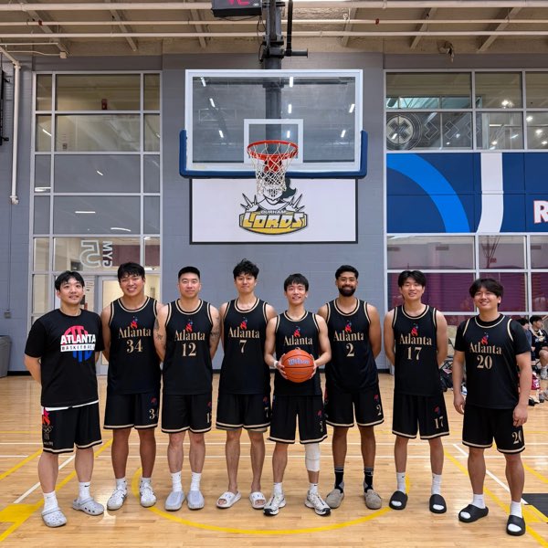 The Atlanta squad in black and gold jerseys, lined up beneath the Durham Lords backboard.