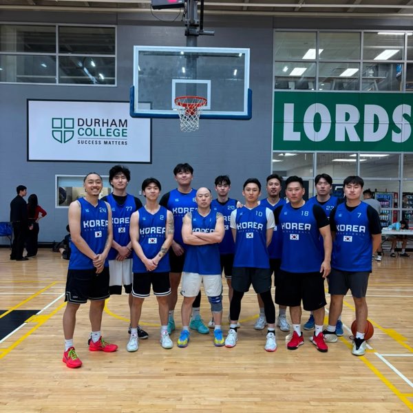 The Toronto squad in blue Korea Basketball jerseys with Korean flag patches, lined up under the hoop.